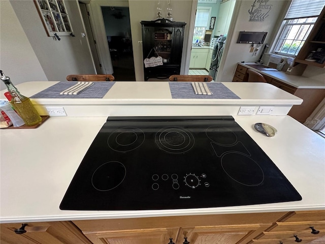 708 E Main St, Wauchula, FL 33873 - interior space featuring black electric cooktop and light countertops