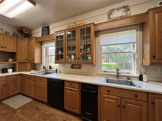 708 E Main St, Wauchula, FL 33873 - kitchen featuring dishwasher, brown cabinetry, wood finished floors, and a sink