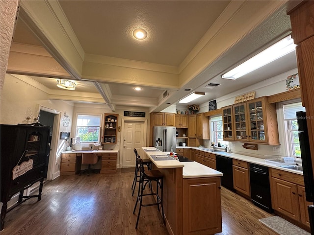 708 E Main St, Wauchula, FL 33873 - kitchen featuring a breakfast bar, stainless steel fridge with ice dispenser, black dishwasher, and brown cabinets
