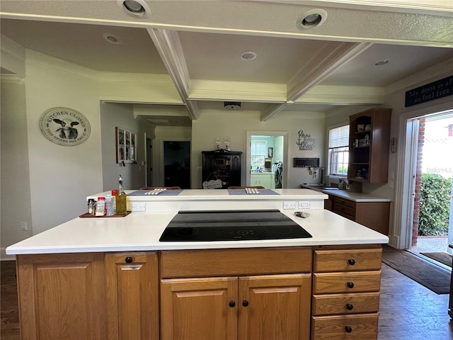 708 E Main St, Wauchula, FL 33873 - kitchen with black electric cooktop, dark wood-style flooring, beamed ceiling, and light countertops