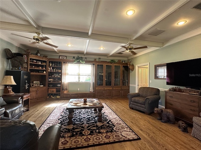 708 E Main St, Wauchula, FL 33873 - living area with coffered ceiling, wood finished floors, a ceiling fan, and a healthy amount of sunlight