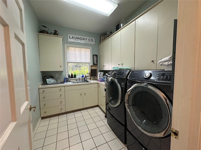 708 E Main St, Wauchula, FL 33873 - laundry area featuring washing machine and dryer, a sink, cabinet space, and light tile patterned floors