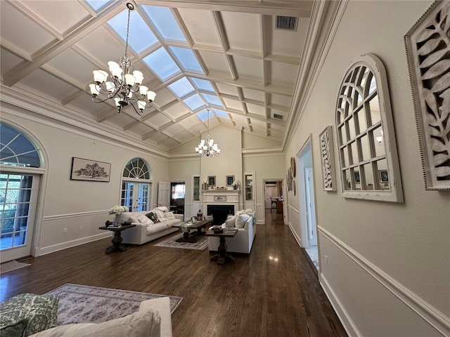 708 E Main St, Wauchula, FL 33873 - living area featuring coffered ceiling, visible vents, dark wood-type flooring, and a notable chandelier