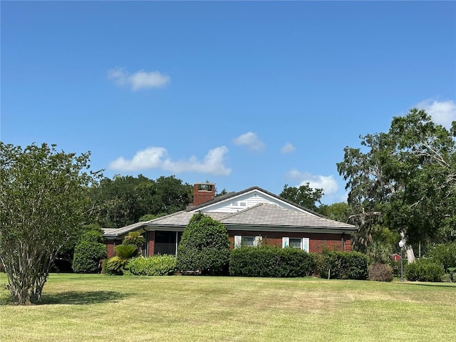 708 E Main St, Wauchula, FL 33873 - exterior space with a front lawn, brick siding, and a chimney
