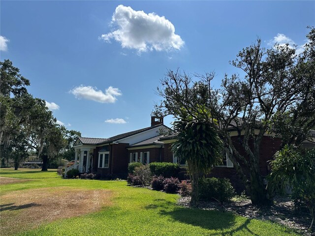 708 E Main St, Wauchula, FL 33873 - view of property exterior with a lawn and brick siding