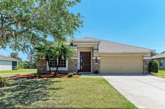 view of front of home featuring a garage, a front lawn, concrete driveway, and stone siding