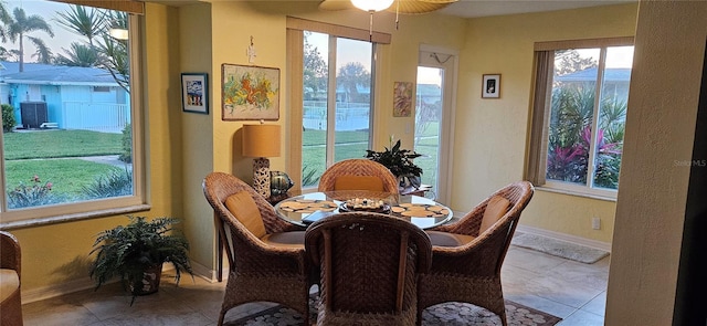 dining room with a wealth of natural light, baseboards, and tile patterned floors