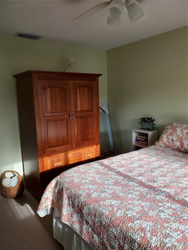 carpeted bedroom featuring ceiling fan and visible vents