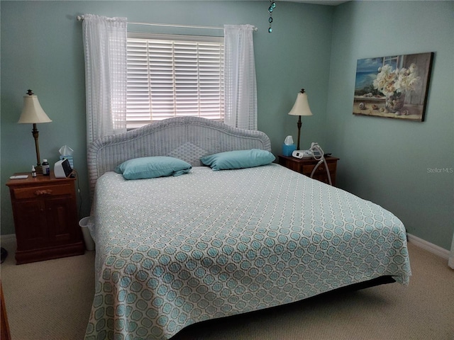 bedroom featuring carpet flooring and baseboards
