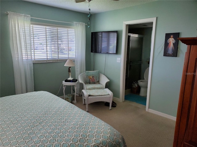 bedroom featuring baseboards, carpet flooring, and ensuite bath
