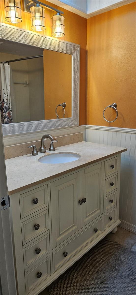 bathroom featuring wainscoting and vanity