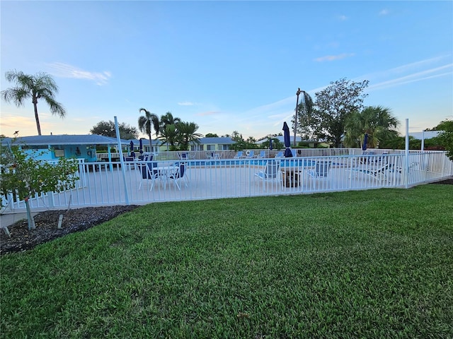 exterior space featuring a community pool, a patio area, and fence
