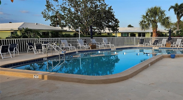 pool featuring a patio area and fence