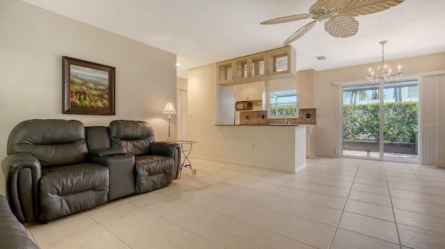 2259 Pueblo Ln Unit V38, Sarasota, FL 34231 - living room featuring light tile patterned flooring, a chandelier, a ceiling fan, and baseboards