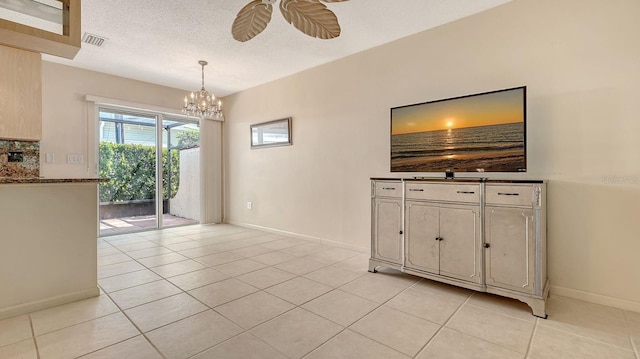 2259 Pueblo Ln Unit V38, Sarasota, FL 34231 - unfurnished dining area with light tile patterned floors, ceiling fan, a chandelier, baseboards, and a textured ceiling