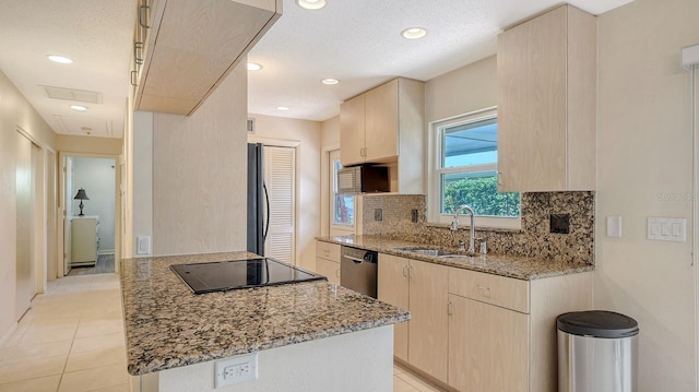 2259 Pueblo Ln Unit V38, Sarasota, FL 34231 - kitchen with light brown cabinetry, black electric stovetop, a sink, stainless steel dishwasher, and recessed lighting