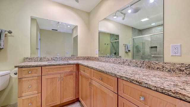 2259 Pueblo Ln Unit V38, Sarasota, FL 34231 - full bath with a shower stall, toilet, rail lighting, and vanity