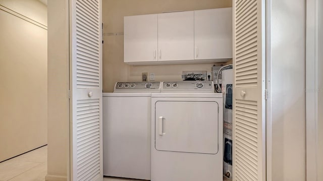 2259 Pueblo Ln Unit V38, Sarasota, FL 34231 - washroom featuring independent washer and dryer, cabinet space, and light tile patterned flooring