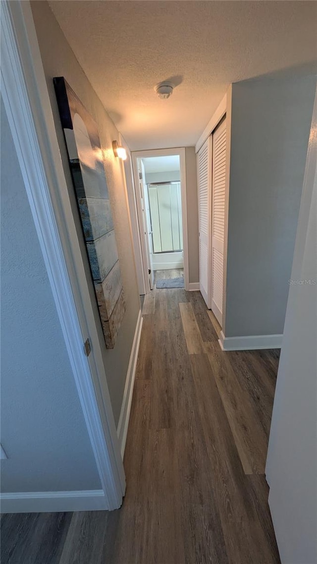 4158 Tamiami Trl Unit V1, Port Charlotte, FL 33952 - hallway featuring dark wood finished floors, baseboards, and a textured ceiling
