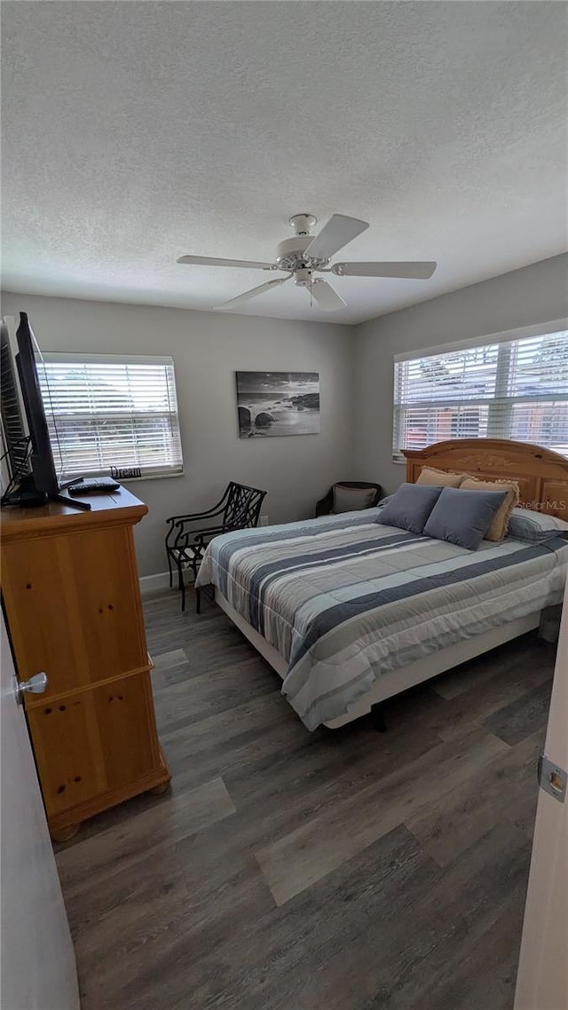 4158 Tamiami Trl Unit V1, Port Charlotte, FL 33952 - bedroom featuring a textured ceiling, a ceiling fan, dark wood-style floors, and baseboards