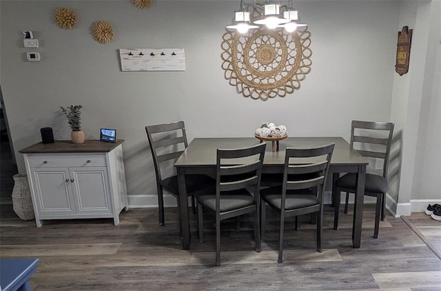 4158 Tamiami Trl Unit V1, Port Charlotte, FL 33952 - dining room with wood finished floors, a notable chandelier, and baseboards