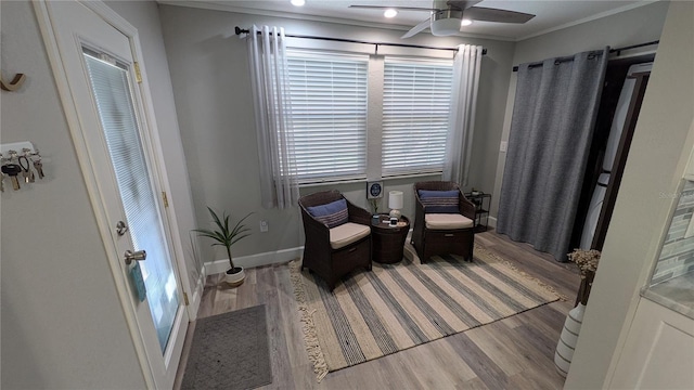 4158 Tamiami Trl Unit V1, Port Charlotte, FL 33952 - living area featuring ornamental molding, a ceiling fan, baseboards, and light wood-type flooring