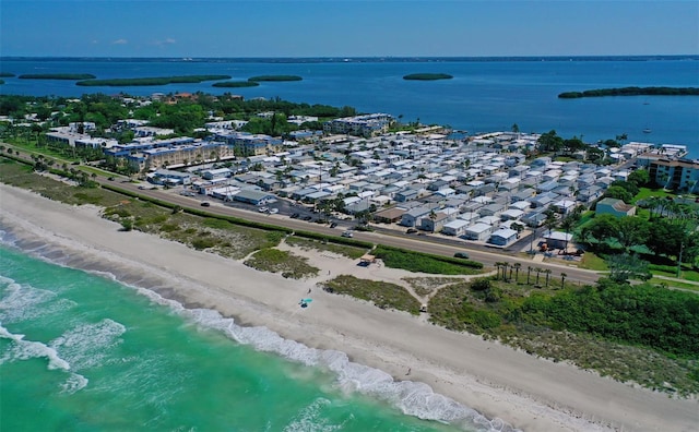 drone / aerial view with a water view and a beach view