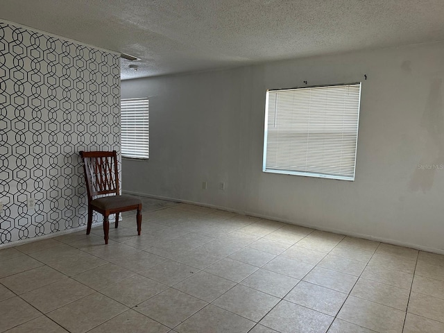 5014 22nd St W, Bradenton, FL 34207 - unfurnished room with baseboards, tile patterned flooring, and a textured ceiling