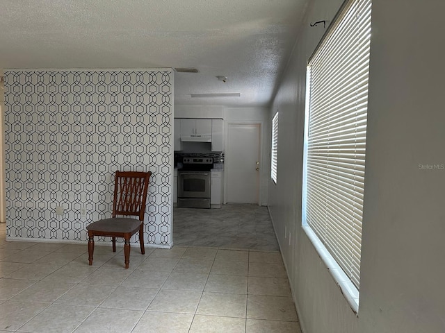 5014 22nd St W, Bradenton, FL 34207 - hallway with light tile patterned floors and a textured ceiling
