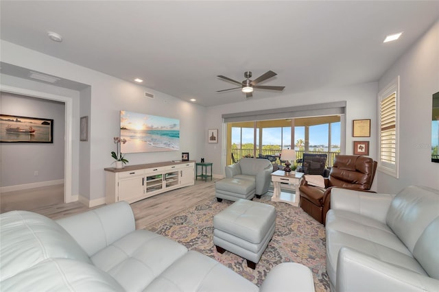 living room with baseboards, ceiling fan, recessed lighting, and light wood-style flooring