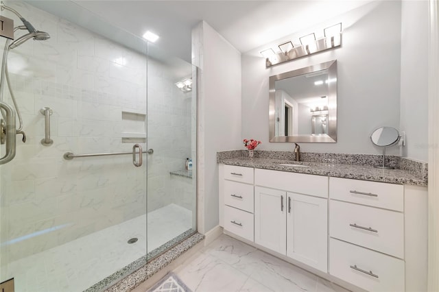 full bathroom featuring vanity, marble finish floor, and a stall shower