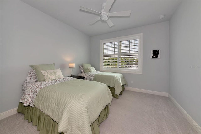 bedroom with baseboards, a ceiling fan, and light colored carpet