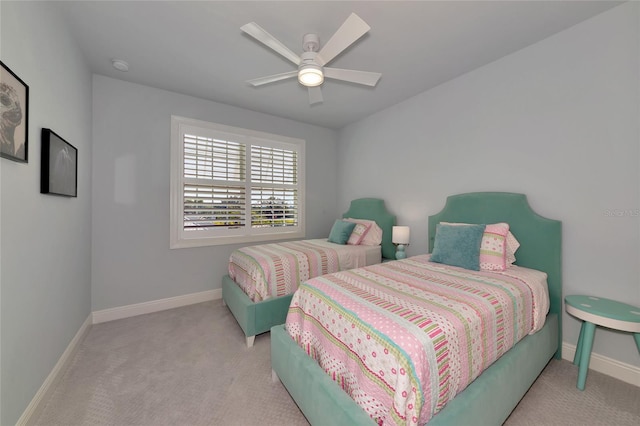 carpeted bedroom with baseboards and ceiling fan