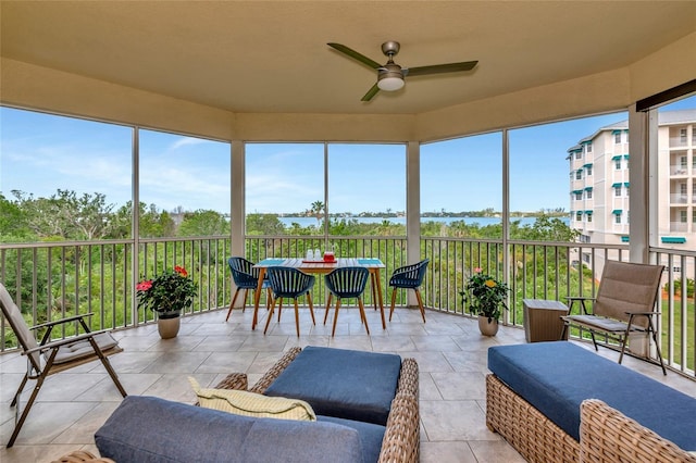 sunroom with a ceiling fan and a wealth of natural light