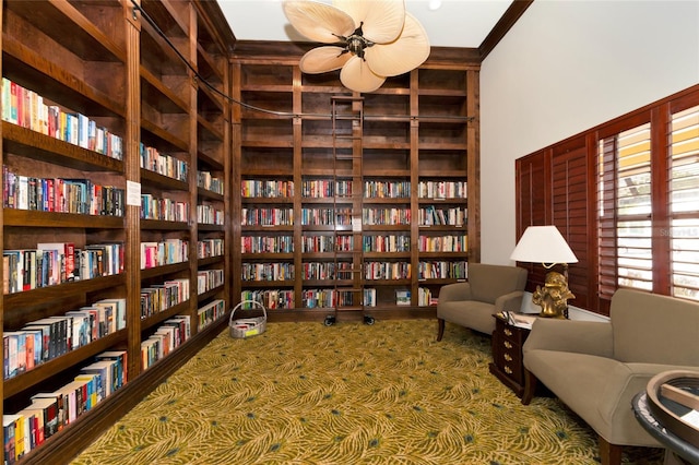 living area featuring a high ceiling and bookshelves