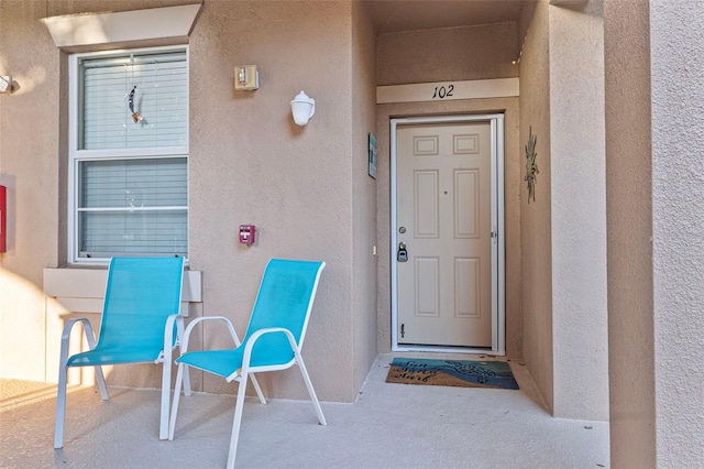 property entrance with stucco siding