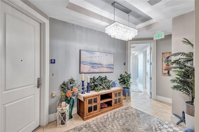 130 Riviera Dunes Way Unit 502, Palmetto, FL 34221 - entrance foyer with visible vents, an inviting chandelier, baseboards, a tray ceiling, and light tile patterned floors