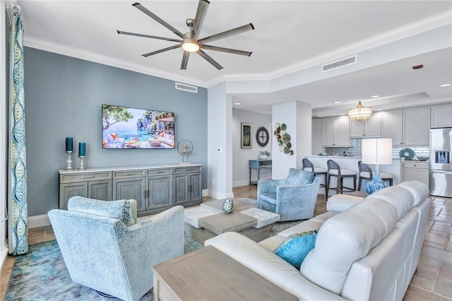 130 Riviera Dunes Way Unit 502, Palmetto, FL 34221 - living area featuring baseboards, a ceiling fan, visible vents, and ornamental molding