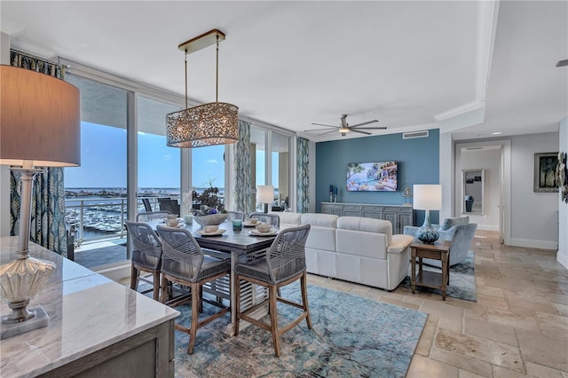 130 Riviera Dunes Way Unit 502, Palmetto, FL 34221 - dining space with stone tile flooring, visible vents, baseboards, expansive windows, and a ceiling fan