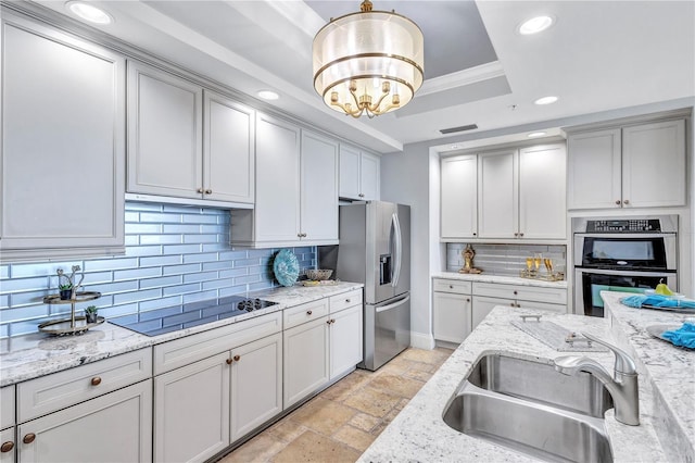 130 Riviera Dunes Way Unit 502, Palmetto, FL 34221 - kitchen featuring a sink, a raised ceiling, stainless steel appliances, recessed lighting, and backsplash