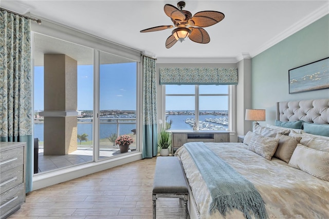 130 Riviera Dunes Way Unit 502, Palmetto, FL 34221 - bedroom featuring crown molding, a water view, ceiling fan, and wood finished floors