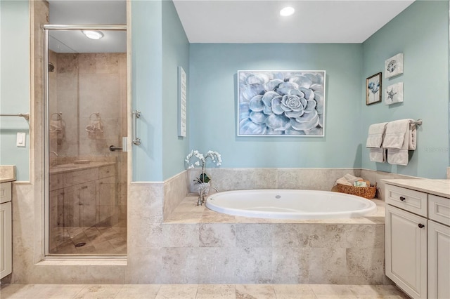 130 Riviera Dunes Way Unit 502, Palmetto, FL 34221 - full bathroom featuring recessed lighting, a shower stall, a garden tub, and vanity