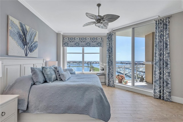 130 Riviera Dunes Way Unit 502, Palmetto, FL 34221 - bedroom with ornamental molding, light wood-style floors, baseboards, a water view, and a ceiling fan