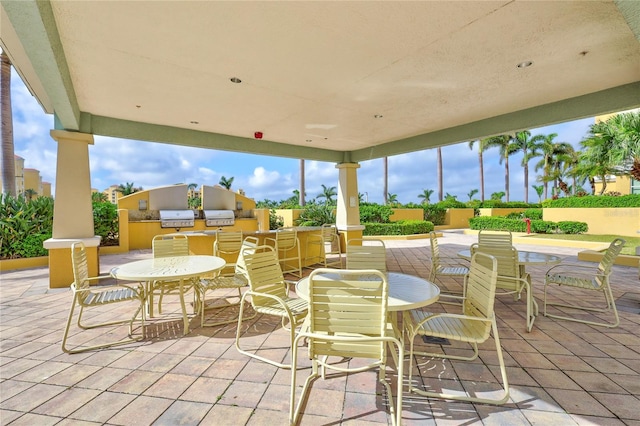 130 Riviera Dunes Way Unit 502, Palmetto, FL 34221 - view of patio / terrace featuring grilling area, fence, outdoor dining space, and area for grilling