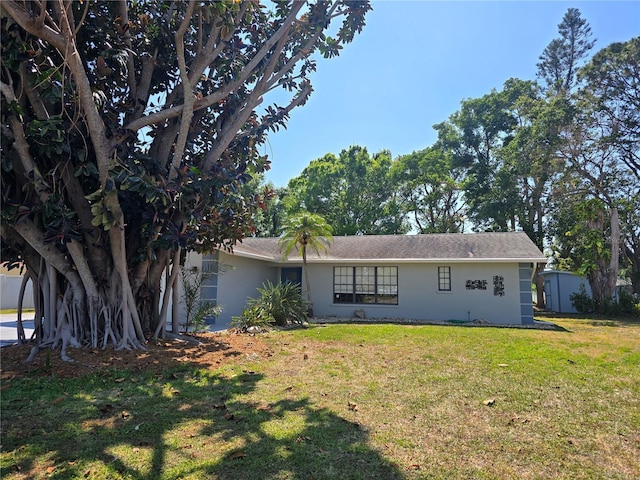2204 34th St W, Bradenton, FL 34205 - back of property featuring stucco siding and a yard