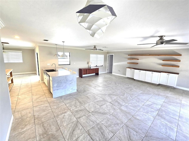 2204 34th St W, Bradenton, FL 34205 - kitchen with ornamental molding, a sink, a ceiling fan, baseboards, and pendant lighting