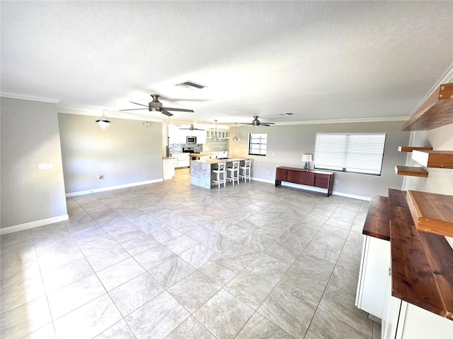 2204 34th St W, Bradenton, FL 34205 - living area featuring ceiling fan, crown molding, and baseboards