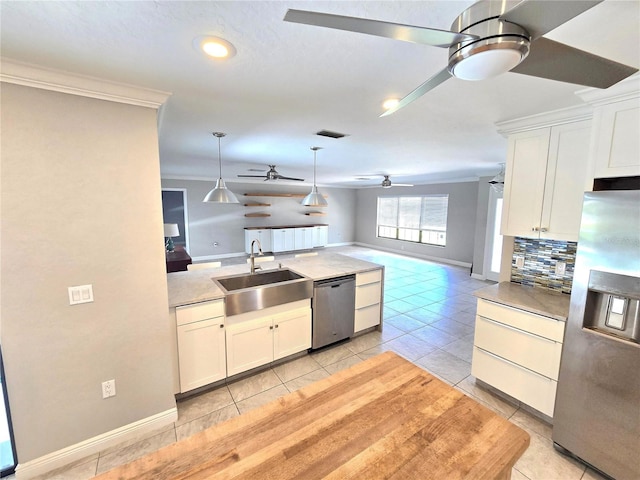 2204 34th St W, Bradenton, FL 34205 - kitchen featuring appliances with stainless steel finishes, a ceiling fan, a sink, open floor plan, and crown molding