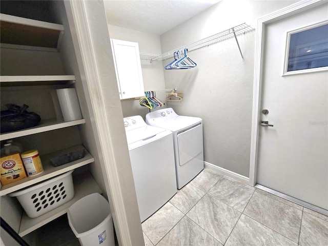 2204 34th St W, Bradenton, FL 34205 - washroom featuring cabinet space, washing machine and dryer, light tile patterned floors, and baseboards