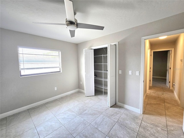 2204 34th St W, Bradenton, FL 34205 - unfurnished bedroom featuring light tile patterned flooring, a closet, ceiling fan, and baseboards
